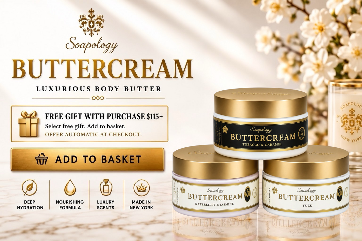 Three Soapology Buttercream body butter jars with gold lids and cream labels are arranged on a reflective surface, with promotional text, a 'Free Gift with Purchase' banner, and floral decorations in the background.