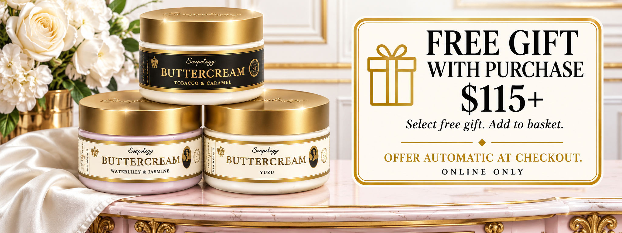 Three jars of Soapology New York Buttercream lotion are arranged on a decorative table next to a white rose arrangement, with a promotional offer card on the right that reads 'FREE GIFT WITH PURCHASE $115+'.