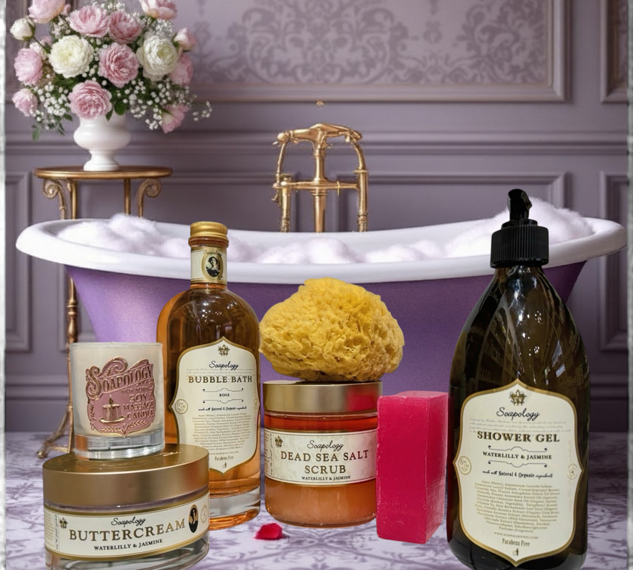 Bath products including a candle, bottle of bubble bath, and scrub in front of a bathtub with flowers.
